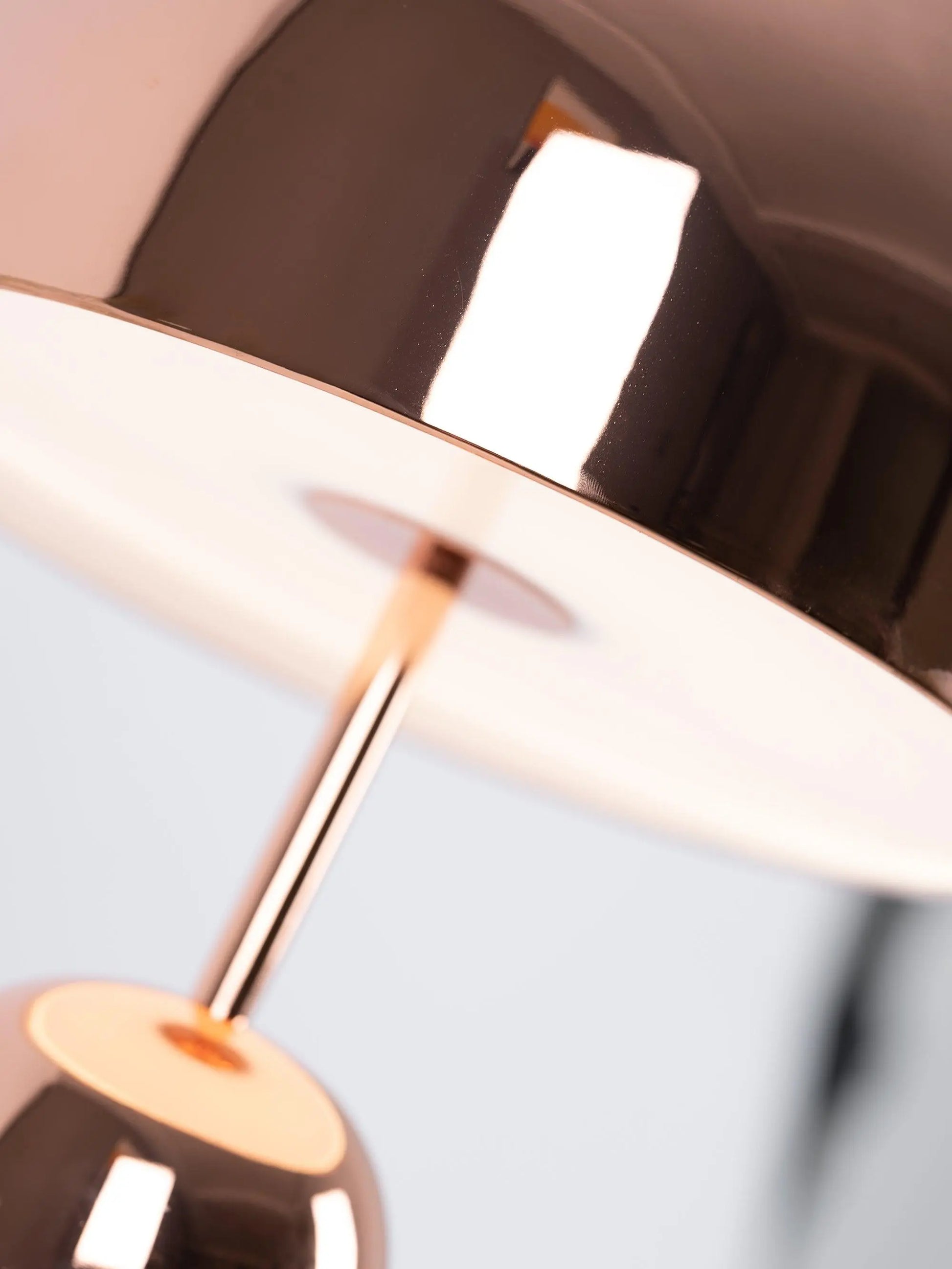 Elegant BellaGlow bell-shaped table lamp in rose gold, adding a touch of sophistication to interior decor.