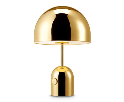 Close-up of BellaGlow table lamp with a bell-shaped gold finish, showcasing its refined metallic details.