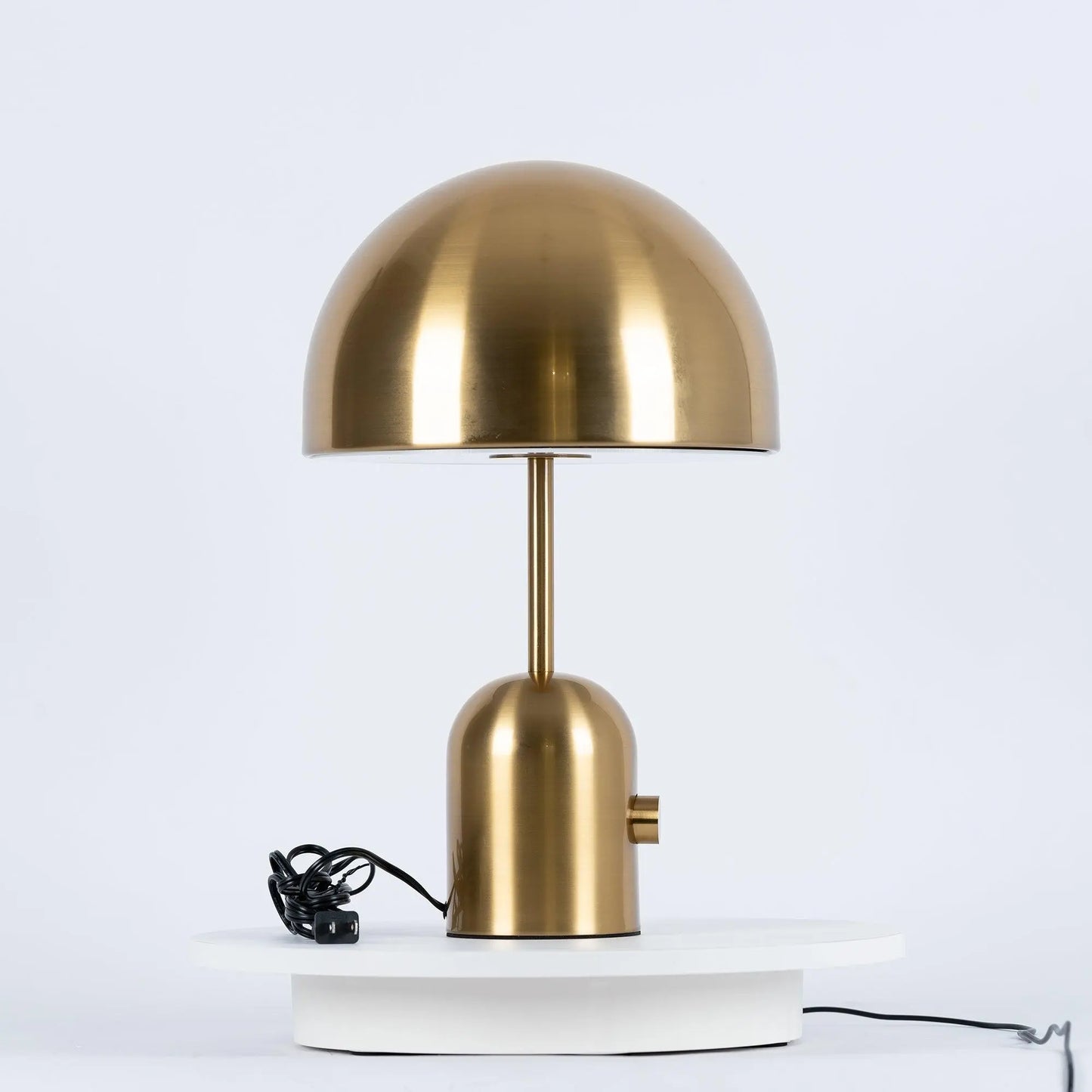 Gold BellaGlow table lamp close-up, showcasing the lamp’s lustrous metallic finish and smooth curves.