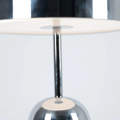 Close-up of BellaGlow table lamp in chrome finish, emphasizing the lamp’s refined design and smooth texture.