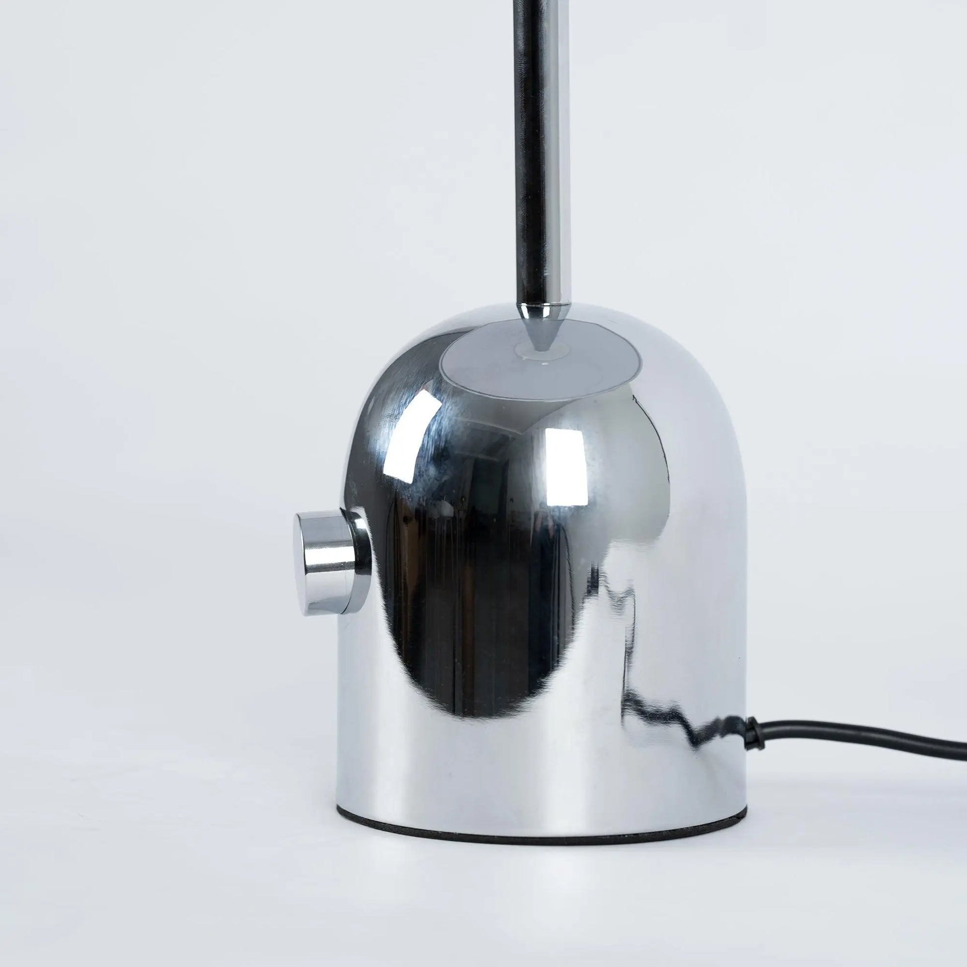 Close-up of BellaGlow table lamp in chrome finish, emphasizing the lamp’s refined design and smooth texture- base.