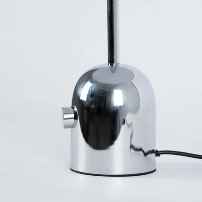 Close-up of BellaGlow table lamp in chrome finish, emphasizing the lamp’s refined design and smooth texture- base.
