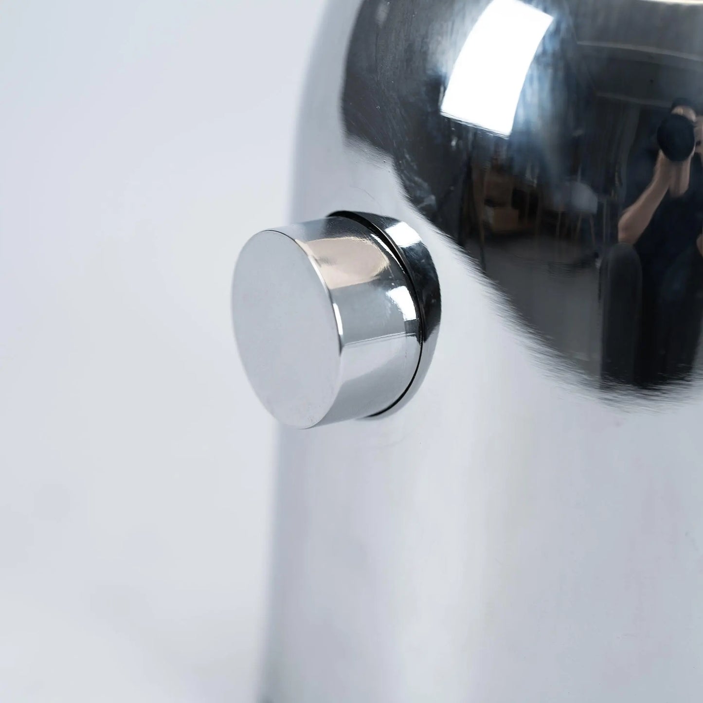 Close-up of BellaGlow table lamp in chrome finish, emphasizing the lamp’s refined design and smooth texture - button.