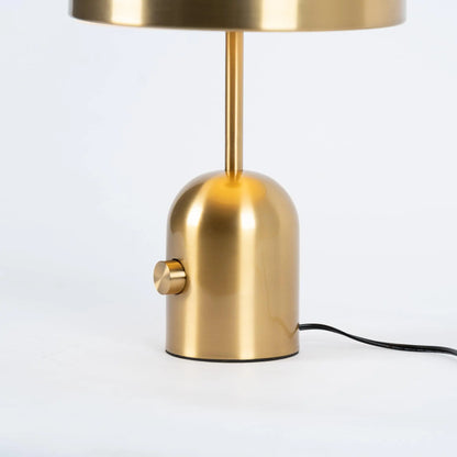 Close-up of BellaGlow table lamp in gold finish, emphasizing the lamp’s refined design and smooth texture.