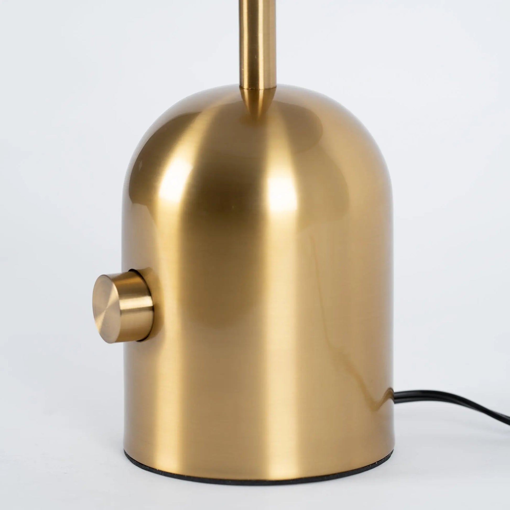 Close-up of BellaGlow table lamp in gold finish, emphasizing the lamp’s refined design and smooth texture - base.