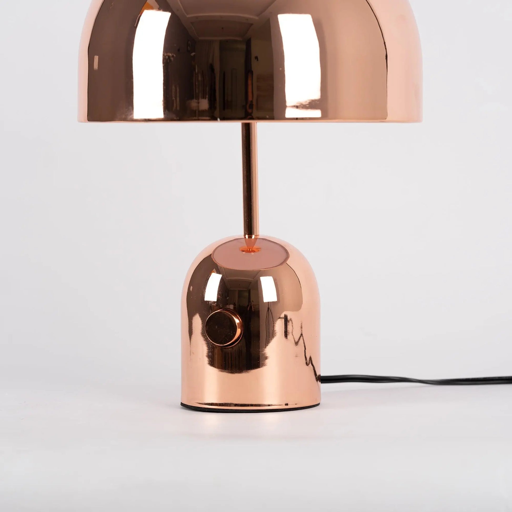 Close-up of BellaGlow table lamp in rose gold finish, emphasizing the lamp’s refined design and smooth texture.