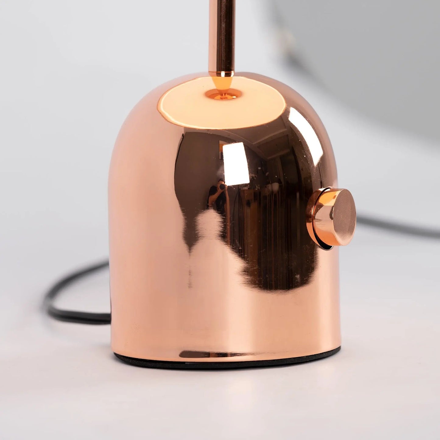 Close-up of BellaGlow table lamp in rose gold finish, emphasizing the lamp’s refined design and smooth texture.