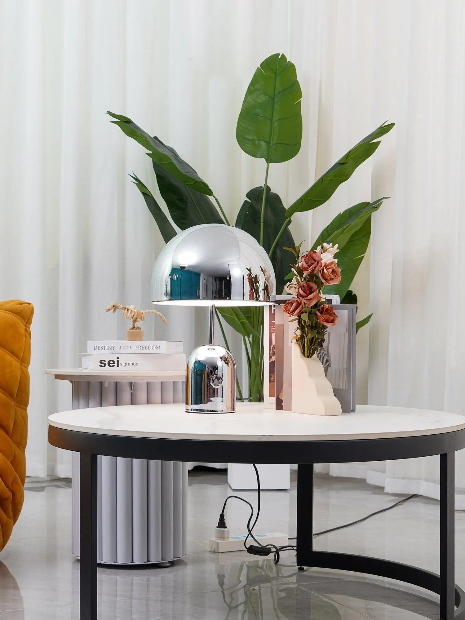 Chrome BellaGlow bell-shaped table lamp illuminated, casting a soft LED glow for cozy ambient lighting.