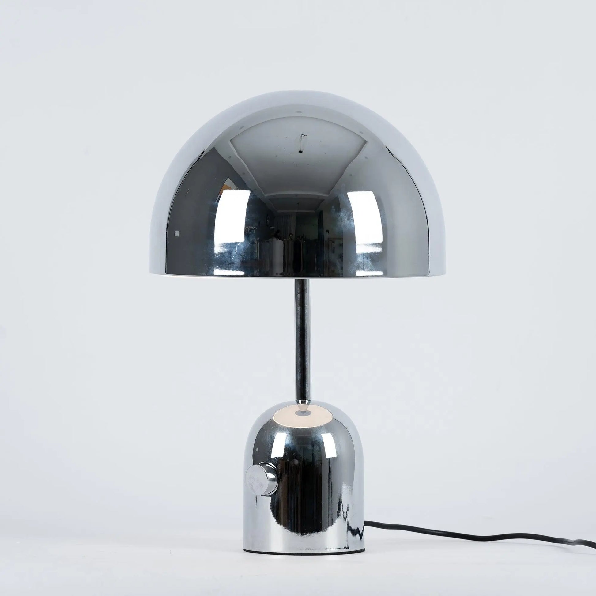 Chrome BellaGlow bell-shaped table lamp illuminated, casting a soft LED glow for cozy ambient lighting.