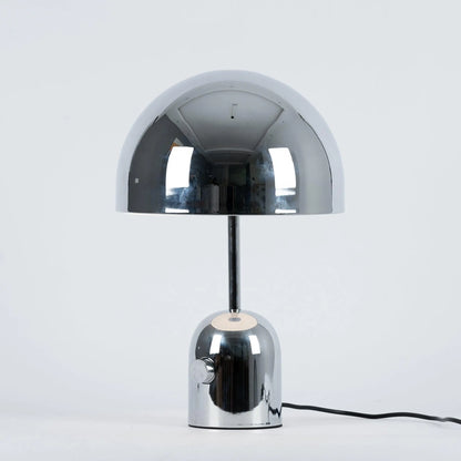 Chrome BellaGlow bell-shaped table lamp illuminated, casting a soft LED glow for cozy ambient lighting.