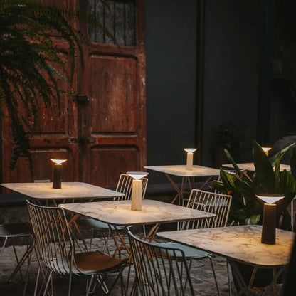 FlexiGlow lamp illuminating a cozy outdoor evening setup, perfect for patios.