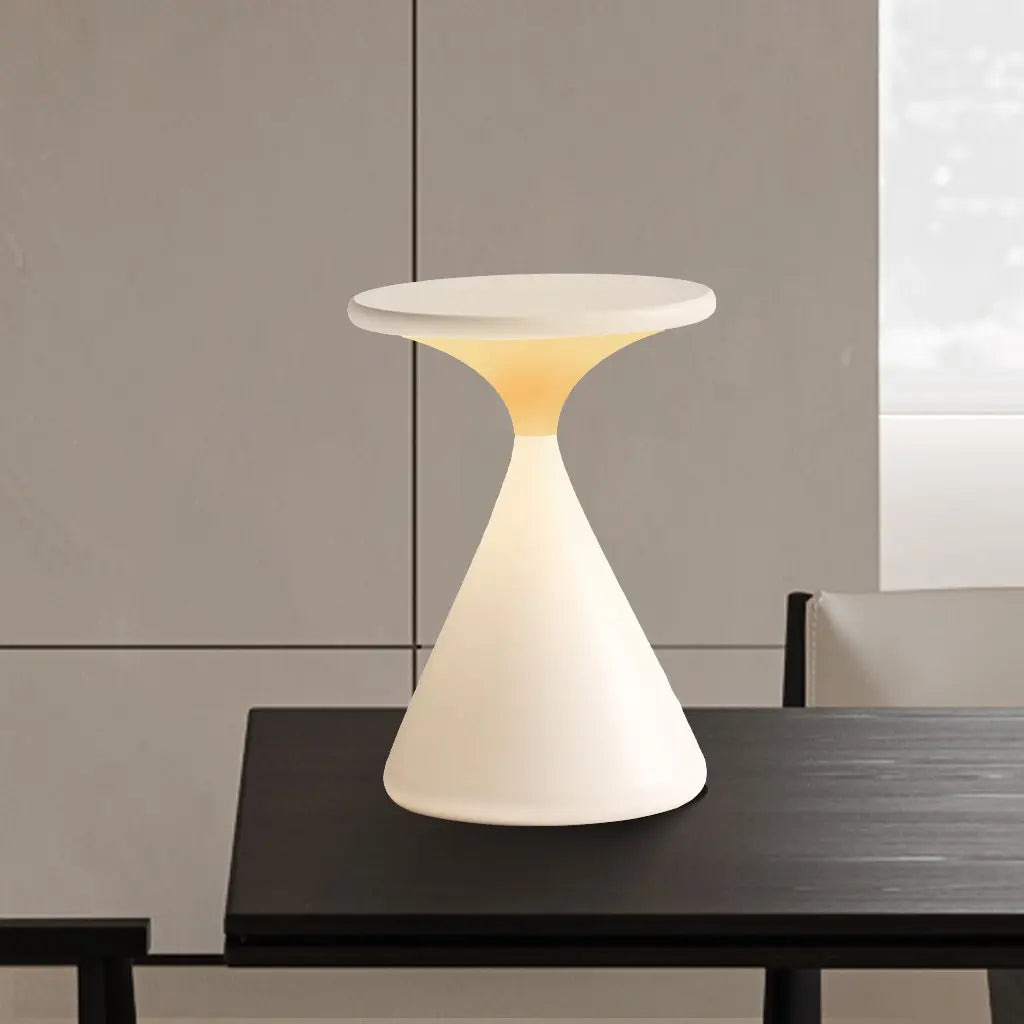 GlowSphere hourglass lamp illuminated, providing soft, ambient lighting for a cozy and inviting atmosphere.