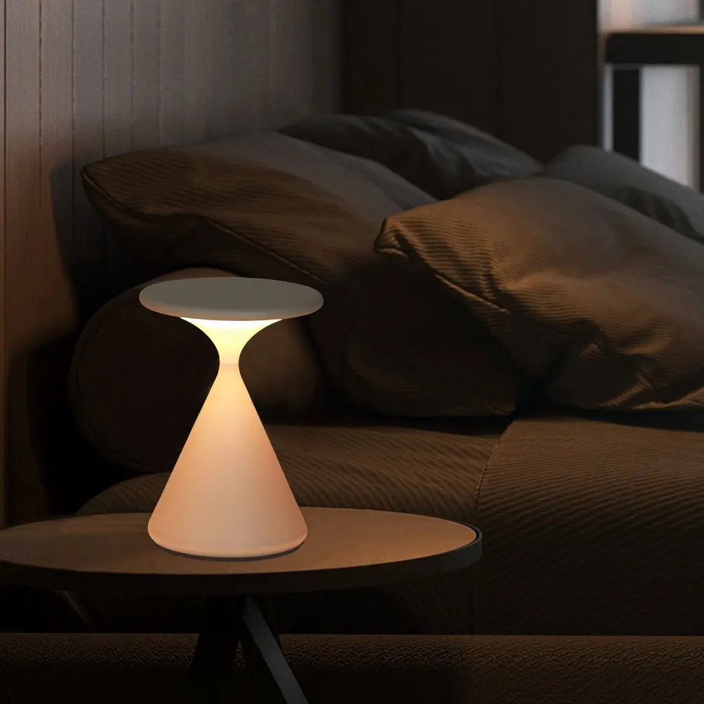 GlowSphere cordless hourglass lamp in a dimly lit room, creating a relaxing and tranquil atmosphere perfect for meditation or unwinding.