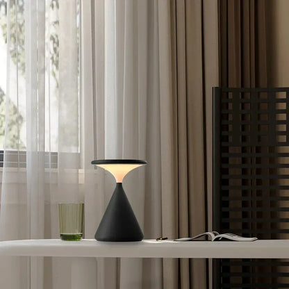 GlowSphere hourglass lamp casting a soft, warm glow, ideal for creating ambient lighting in a living room or bedroom.