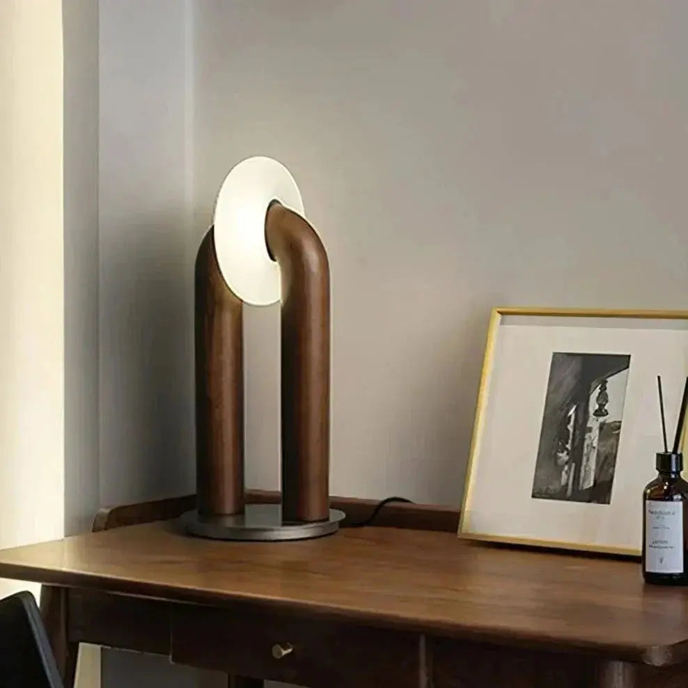 LumiArch lamp illuminating a modern desk workspace