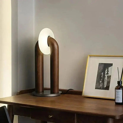 LumiArch lamp illuminating a modern desk workspace