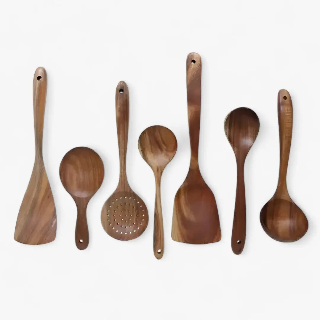 Close-up of the NatuRease teak wood kitchen utensils, highlighting the smooth, polished finish and natural wood grain.